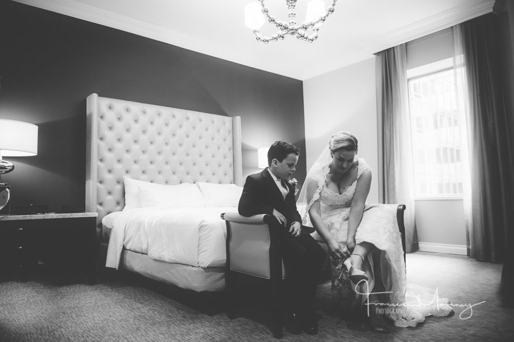 bride puts on her wedding shoes as her son looks on photographed in a journalistic style Collingwood Wedding Photographer-4731