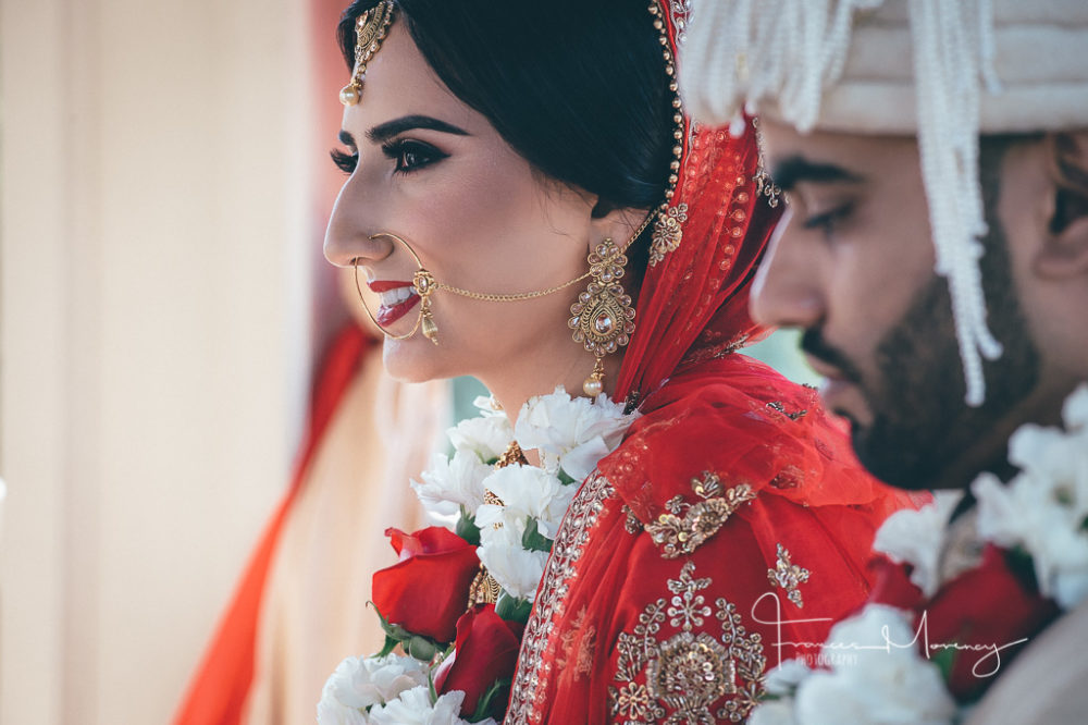 Indian bride in red and groom in cream with lots of jewellery Royal Ambassador Photographer-0708