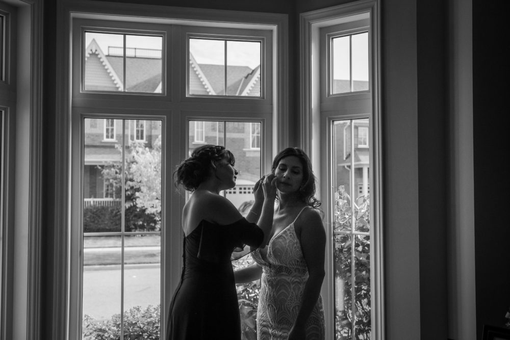 bride and daughter in front of window