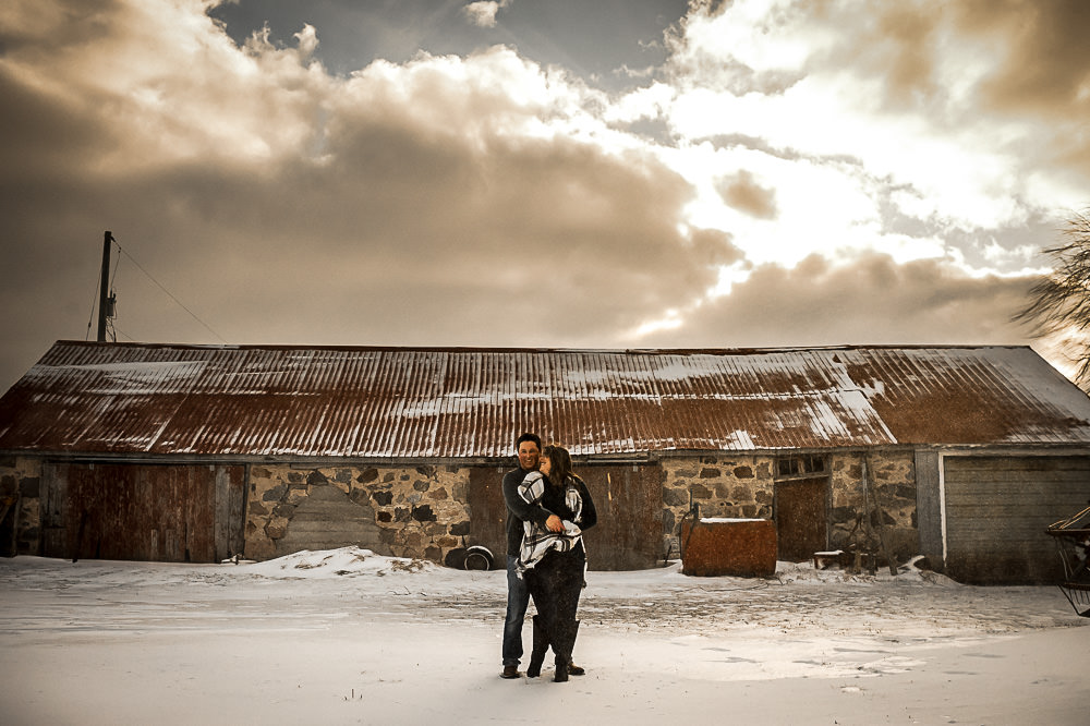 photo in front of stone barn with sun light shining through clouds in Owen Sound