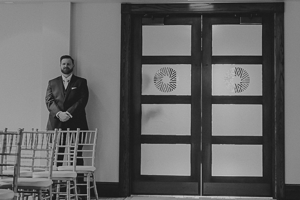 groom waiting to take his spot at alter
