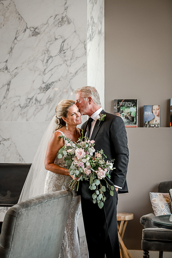 wedding portrait in front entrance of Adamo