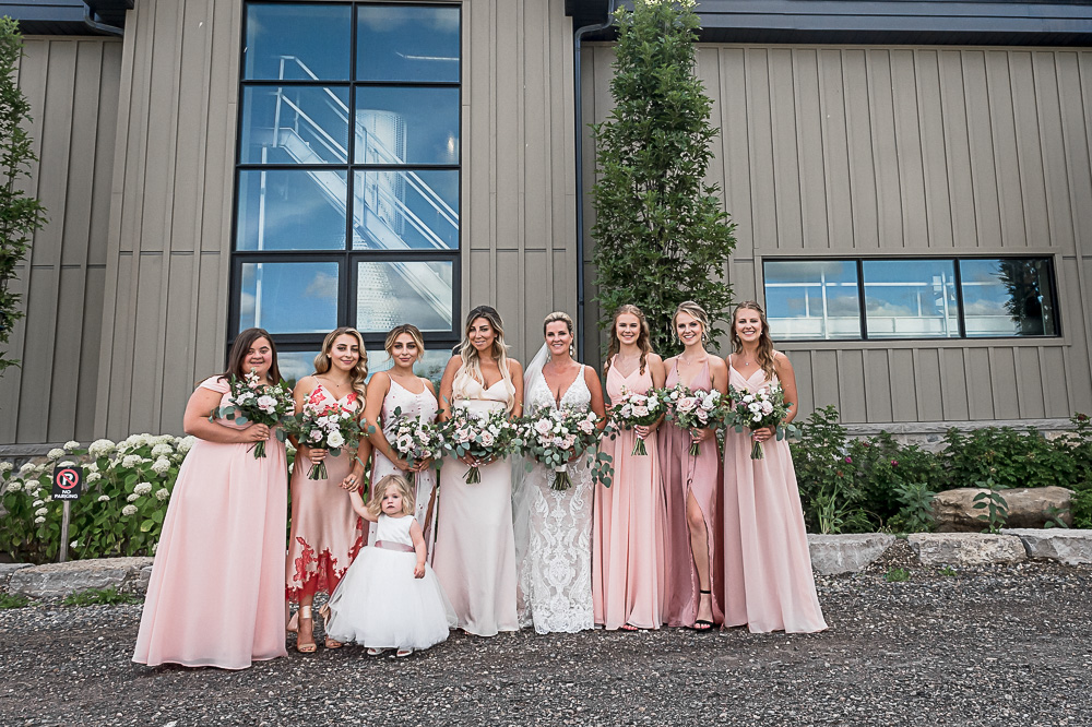 wedding party photos in front of Adamo