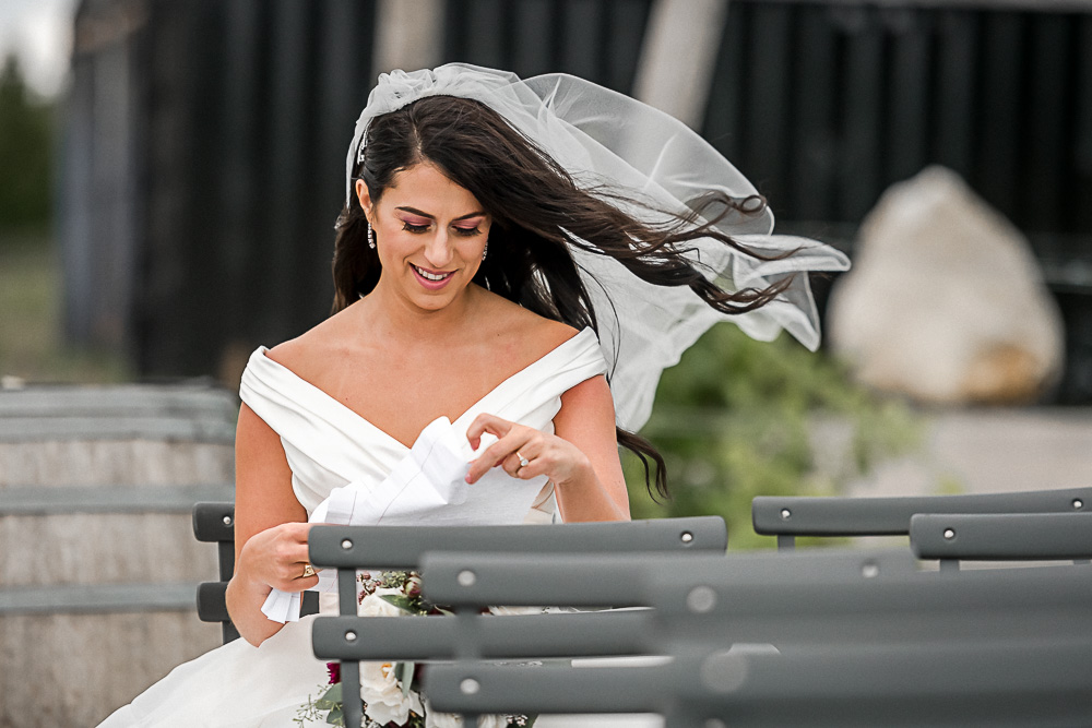 bride reading letter from groom in wind