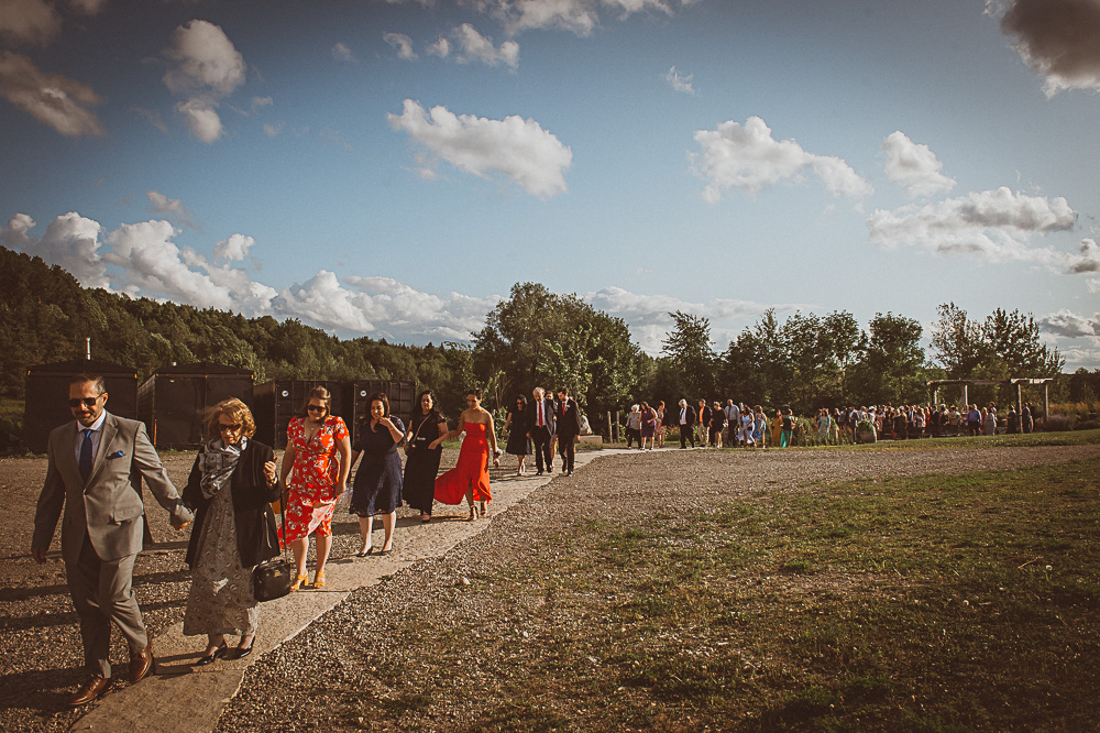 wedding guests leaving ceremony in single file