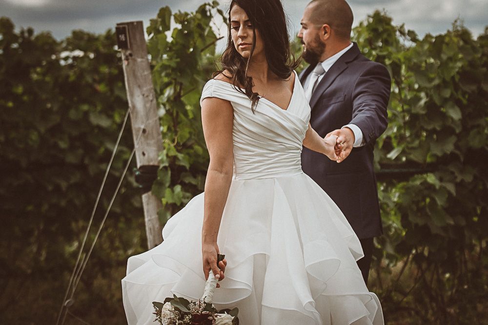 bride and groom holding hands apart
