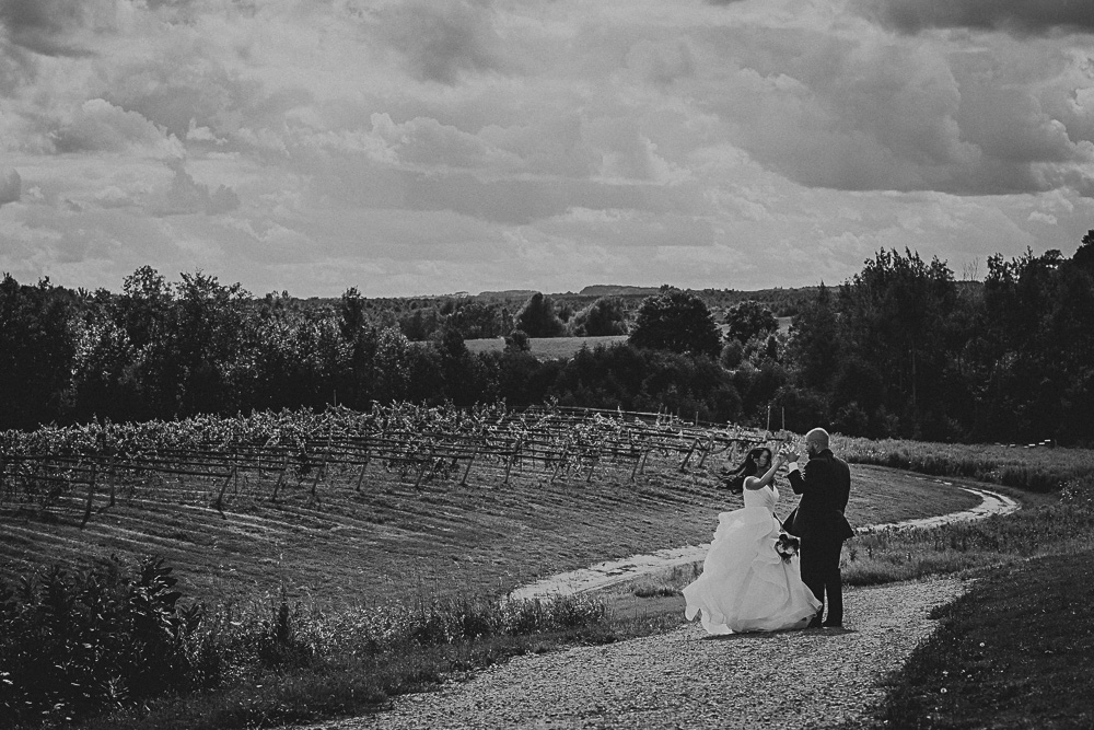 BW portrait of bride groom on hill