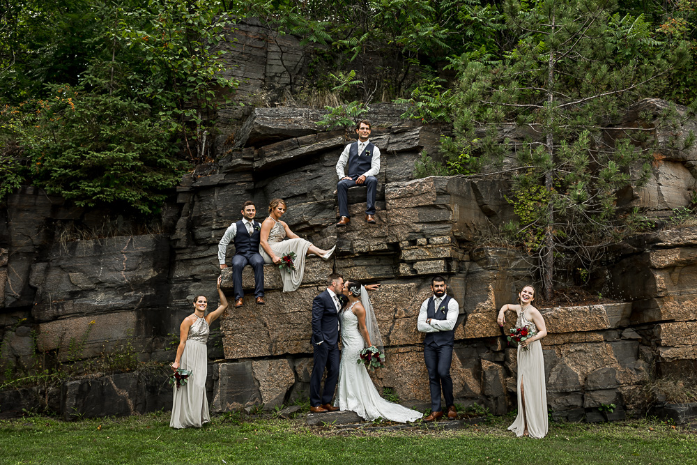wedding party photo with rock wall