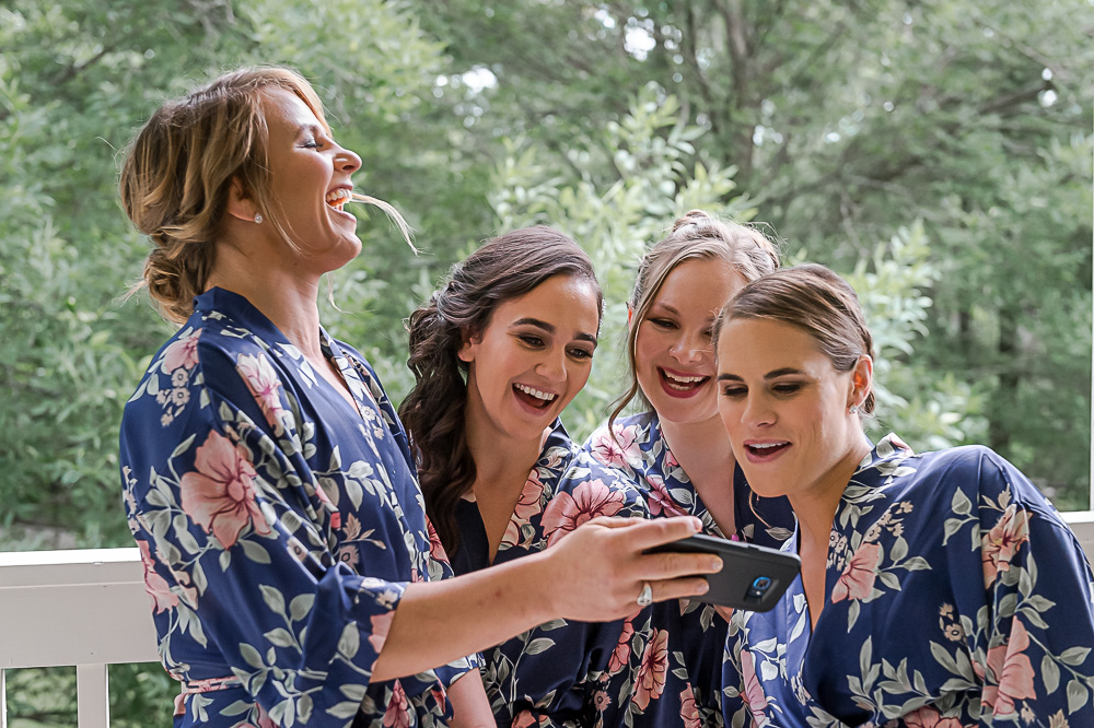 bridesmaids in robes taking selfies