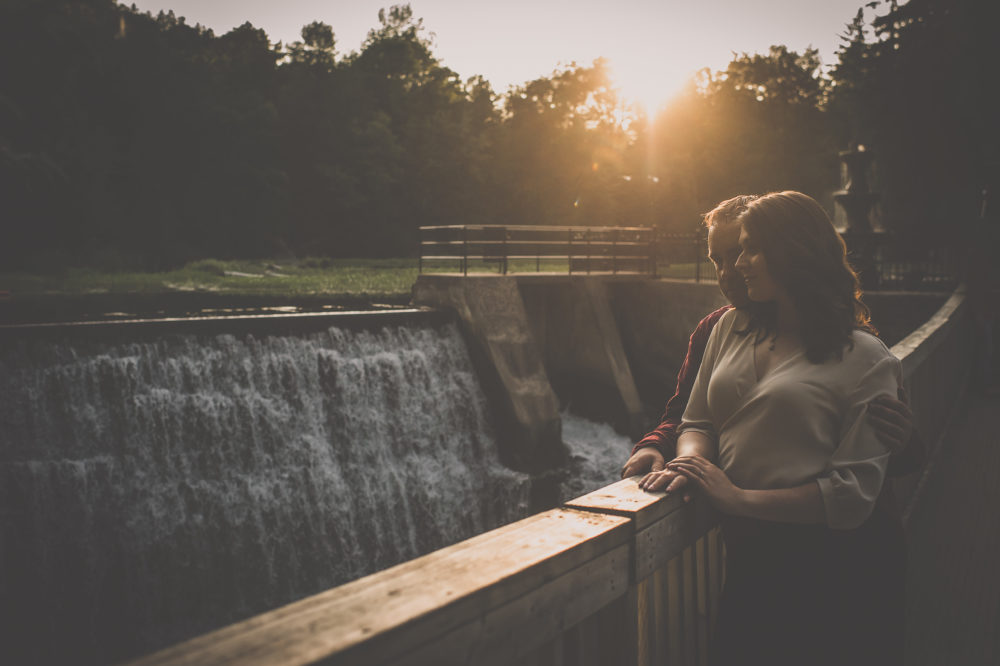Couple on suspension bridge at sunset