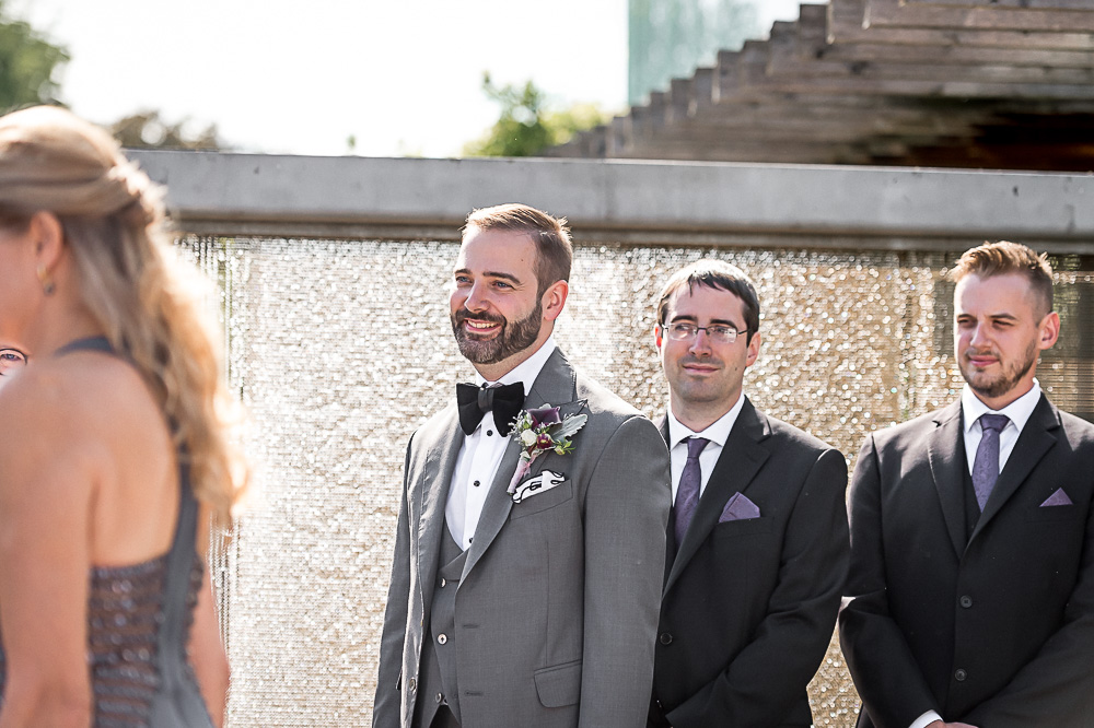 groom sees bride walking down aisle