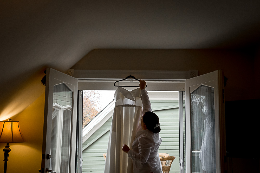 bride reaching for wedding dress