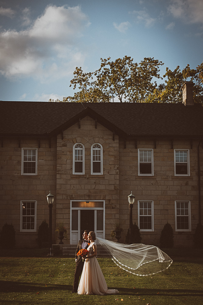 wedding couple in front of Springer Estate