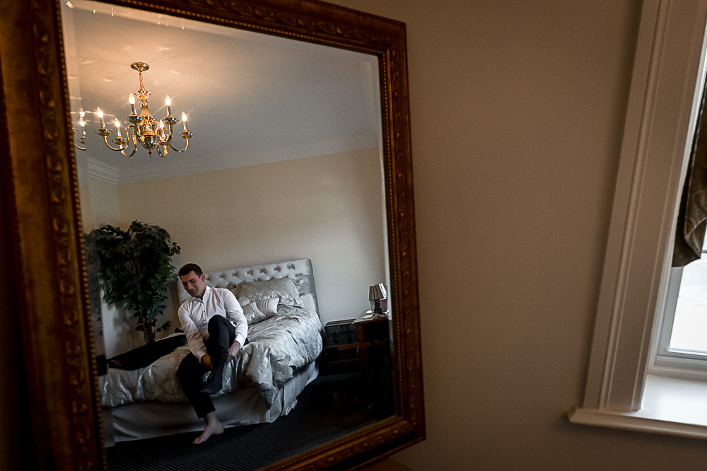 groom reflected in mirror