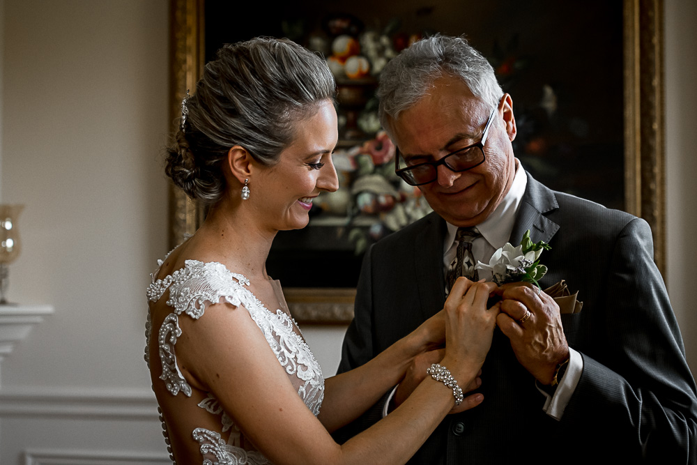bride helps dad with flowers