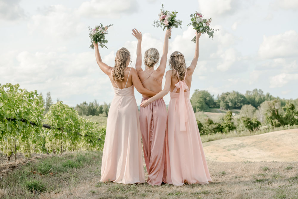bridesmaid in vineyard with pink dresses