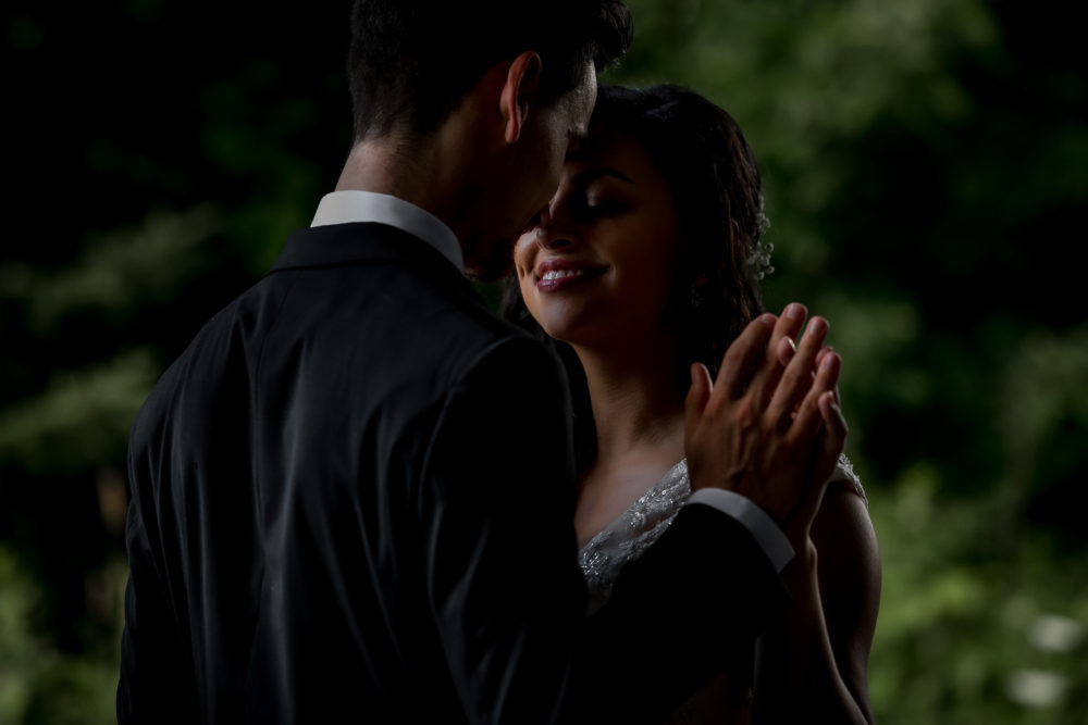 rim light on couple in trees