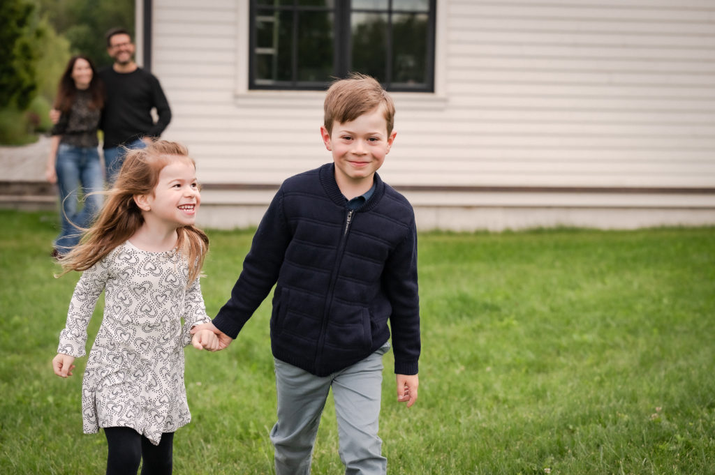 kids running with parents in background