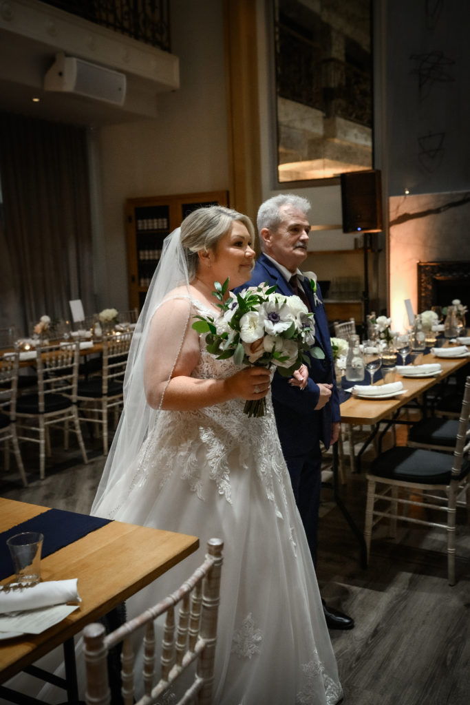 bride and father walking up the aisle at Terroni Restaurant
